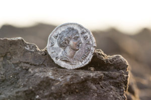 Finding of a Roman denarius by an archaeologist Finding of a Roman denarius by an archaeologist
